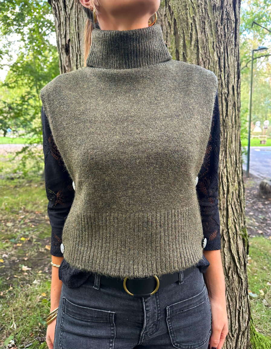 Craquez pour le Pull LIZA kaki sans manches en maille toute douce. Le nouveau best seller de votre garde robe pour cet hiver ! Col roulé Fabriqué en maille douce et stretch Boutons bijoux sur les côtés On aime le porter avec une jolie blouse ample par dessous, un pantalon noir ou beige assez chic et de jolies baskets pour casser le look !