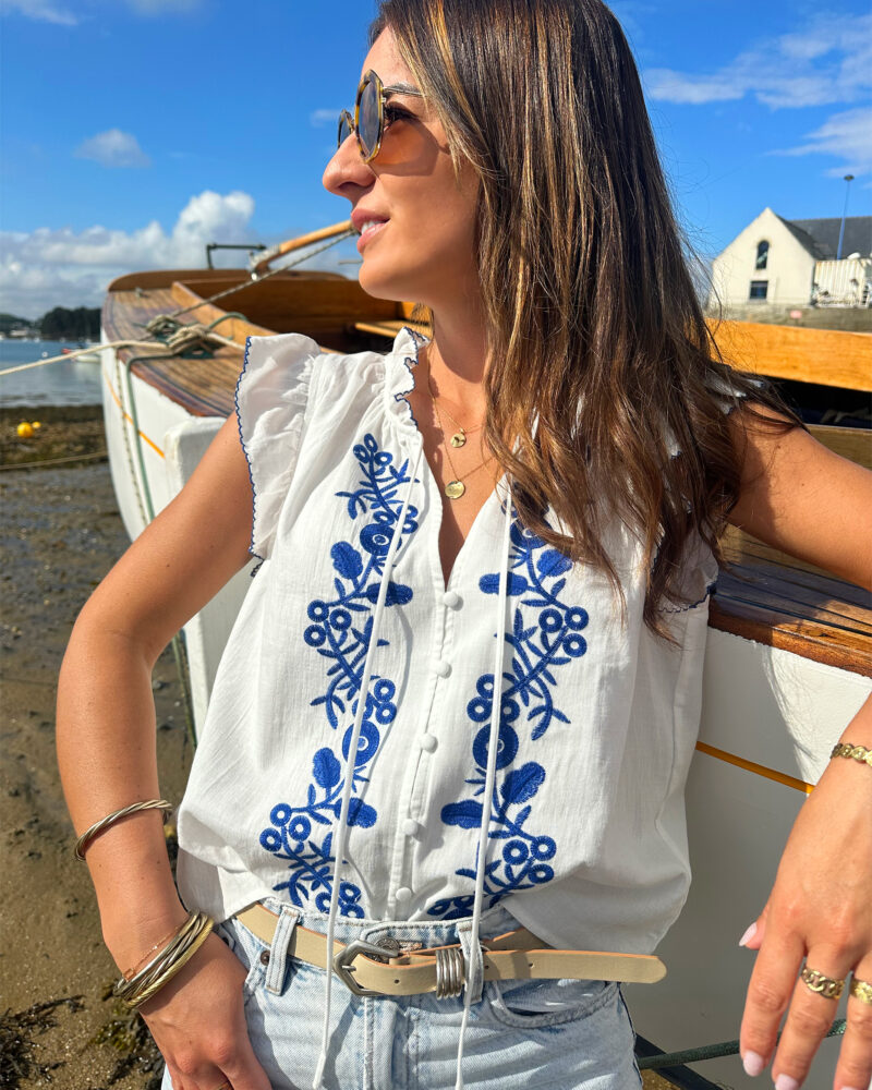 Le Top Valentina représente l’élégance et la féminité grâce à ses somptueux détails en broderie bleue. Ses détails apporteront une touche de romantisme à vos looks. Idéale à porter avec un jean ou un short taille haute. Joli décolleté V Volants à l’encolure et aux manches Modèle boutonné sur l’avant 2 liens Détail de broderies bleues sur l’avant