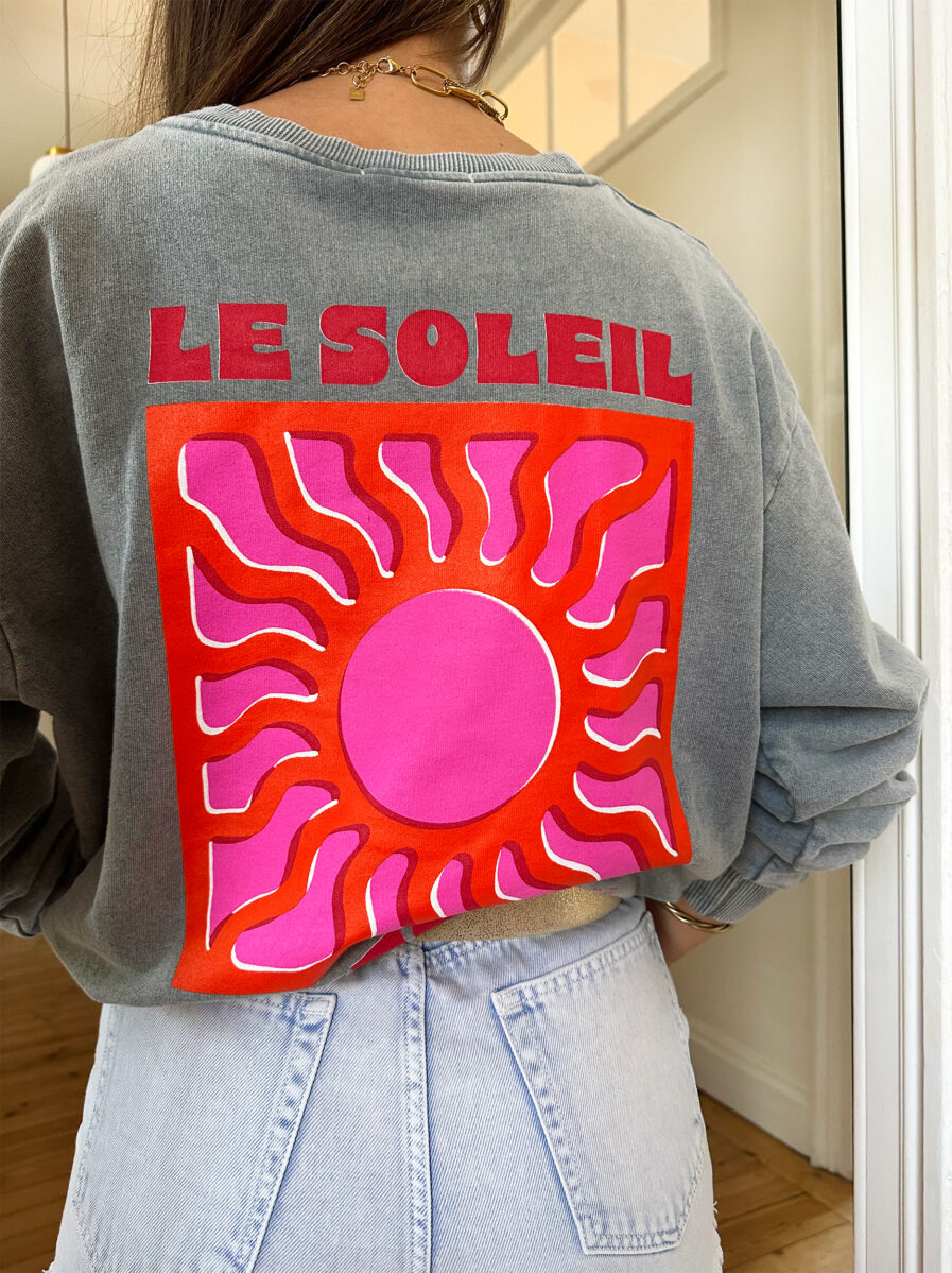 Adoptez un look ensoleillé avec nos sweats Le Soleil ajoutant une touche estivale et positive à votre tenue ! Ce sweat gris 100% coton mise sur le confort sans faire l’impasse sur le style. – Son col rond et sa coupe avec le bout des manches et le bas du sweat élastiqué en font une pièce facile à porter au quotidien. – Ce qui le rend unique ? Un logo coloré sérigraphié sur le devant, représentant un soleil accompagné de l’inscription « Le Soleil » dans des teintes chaudes de rose et d’orange. – À l’arrière, ce même motif est repris en version agrandie, avec l’inscription Le soleil. – Une pièce pleine de bonne humeur, parfaite pour faire rayonner vos looks, même les jours plus frais.